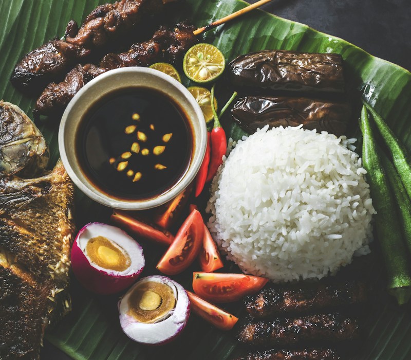 Filipino food spread on banana leaves